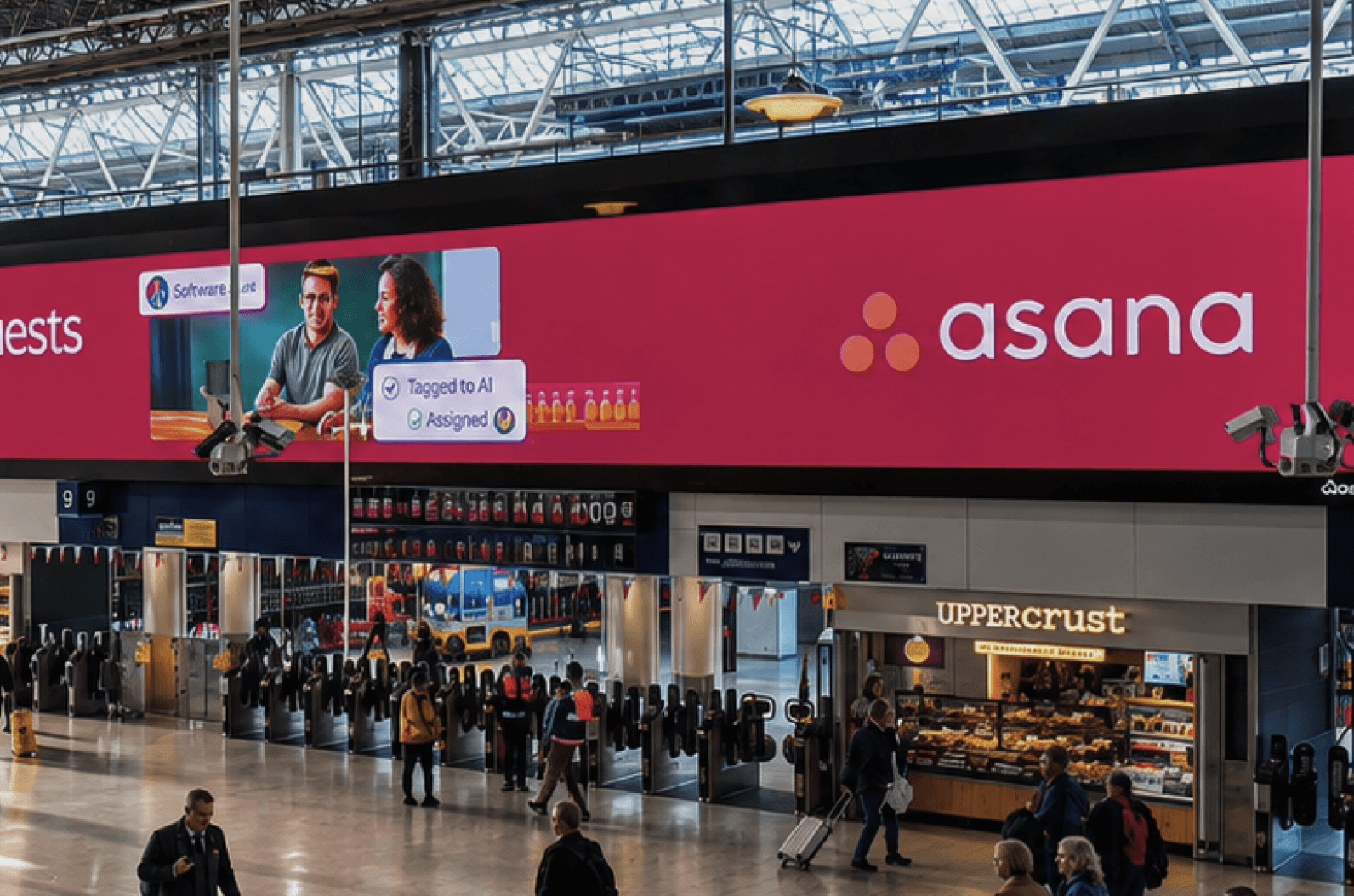 Asana logo end of the station billboard above Upper Crust
