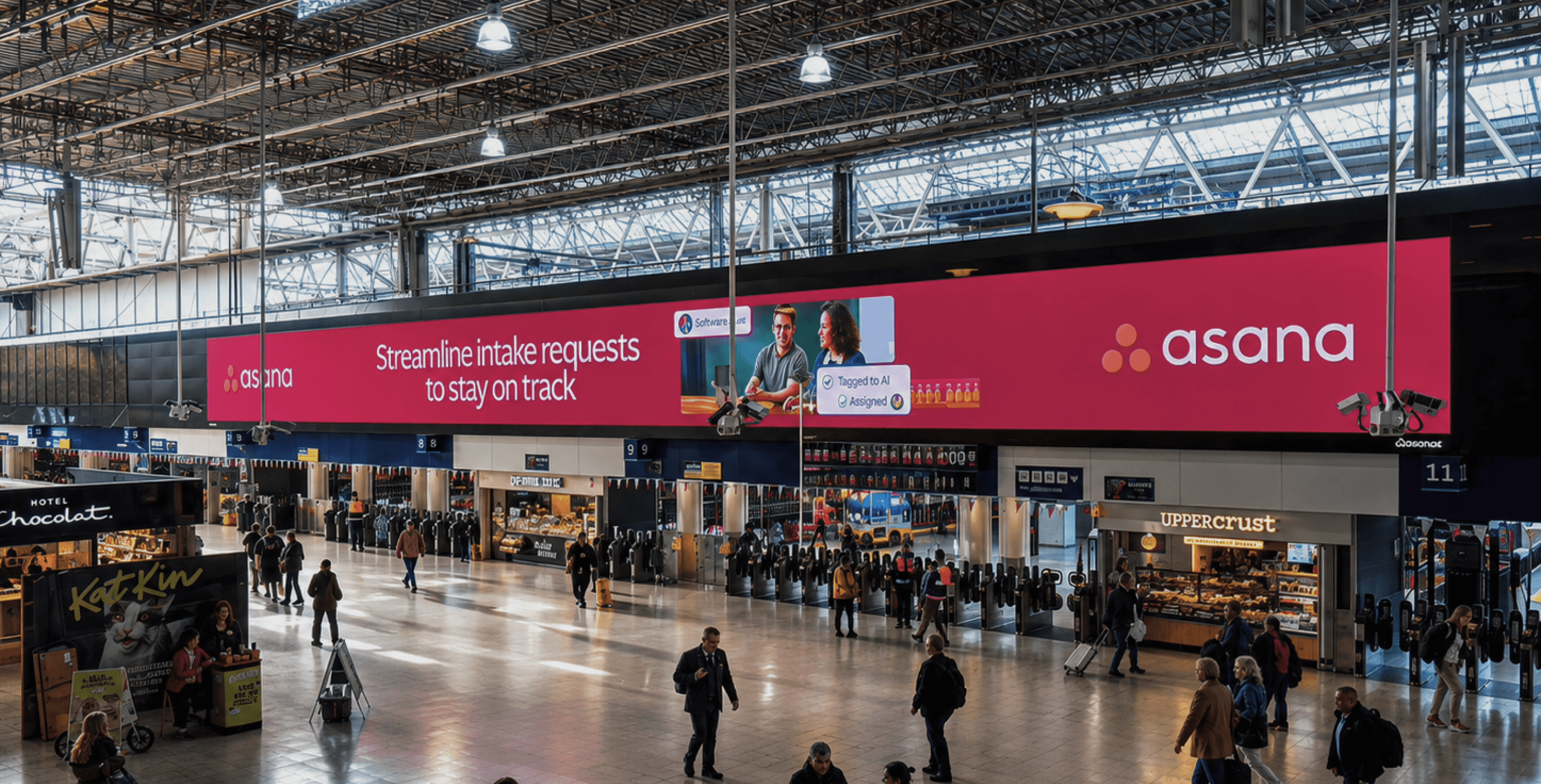 Asana station billboard spanning the concourse at Waterloo