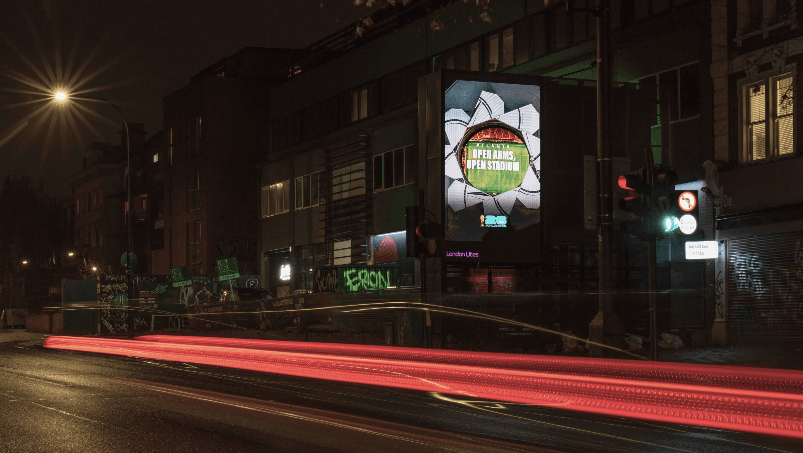 Atlanta ‘Open Arms, Open Stadium’ billboard on a London street at night