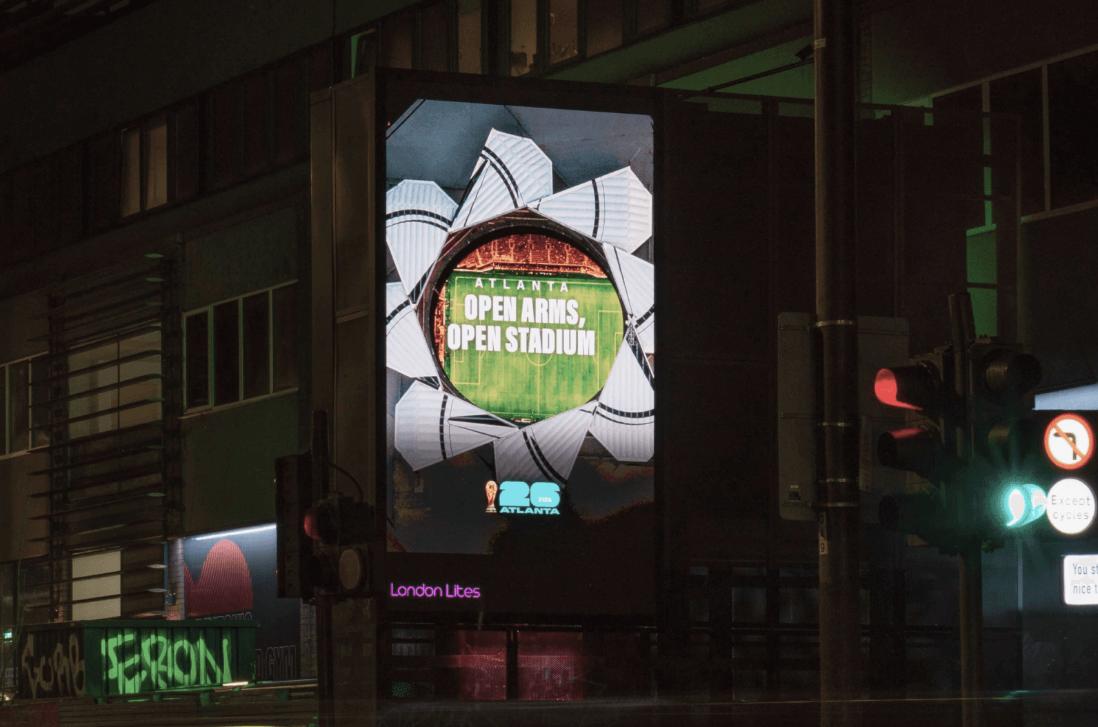 Atlanta ‘Open Arms, Open Stadium’ billboard on a street at night