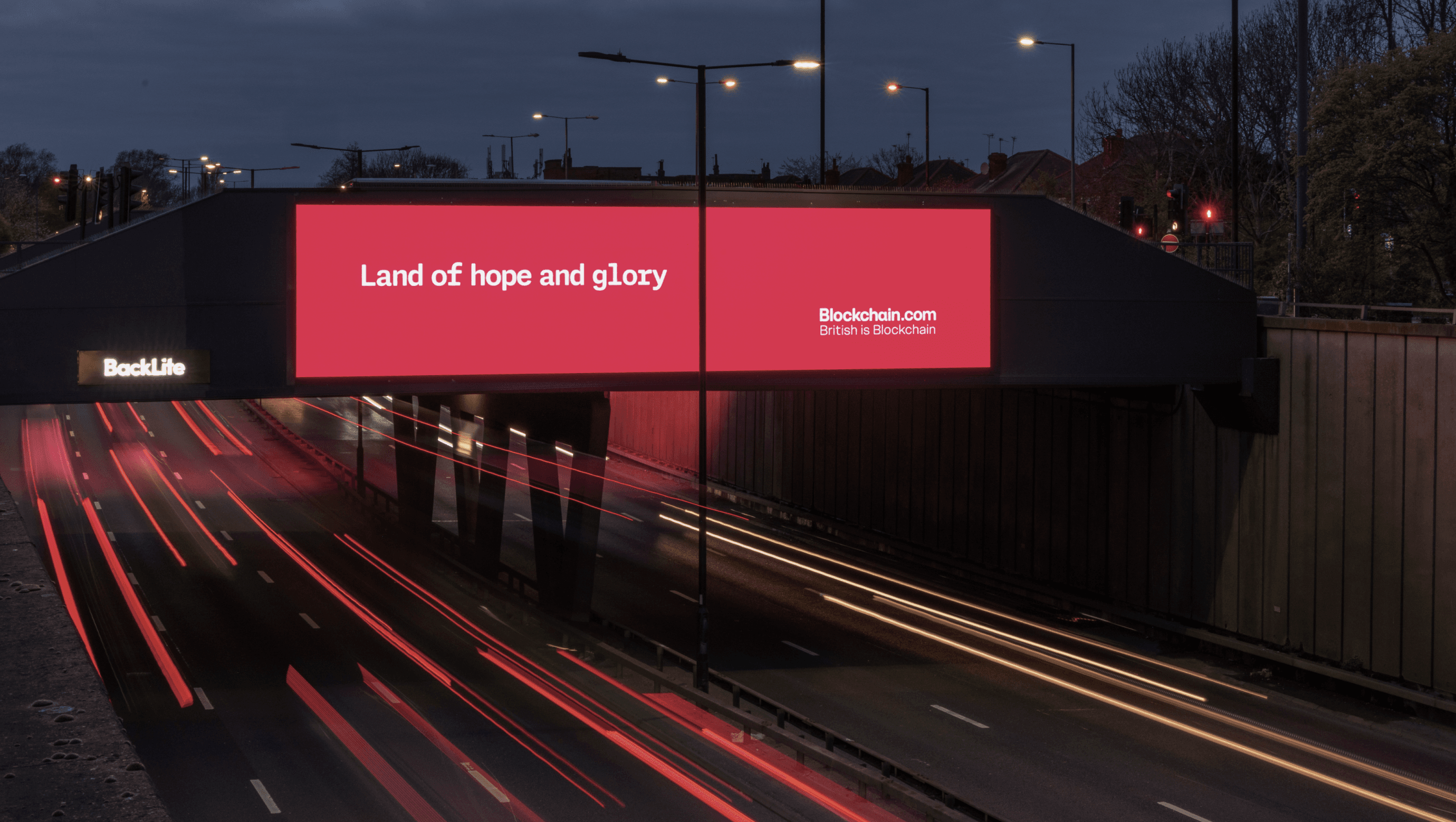 Blockchain.com ‘Land of hope and glory’ billboard over a road at dusk