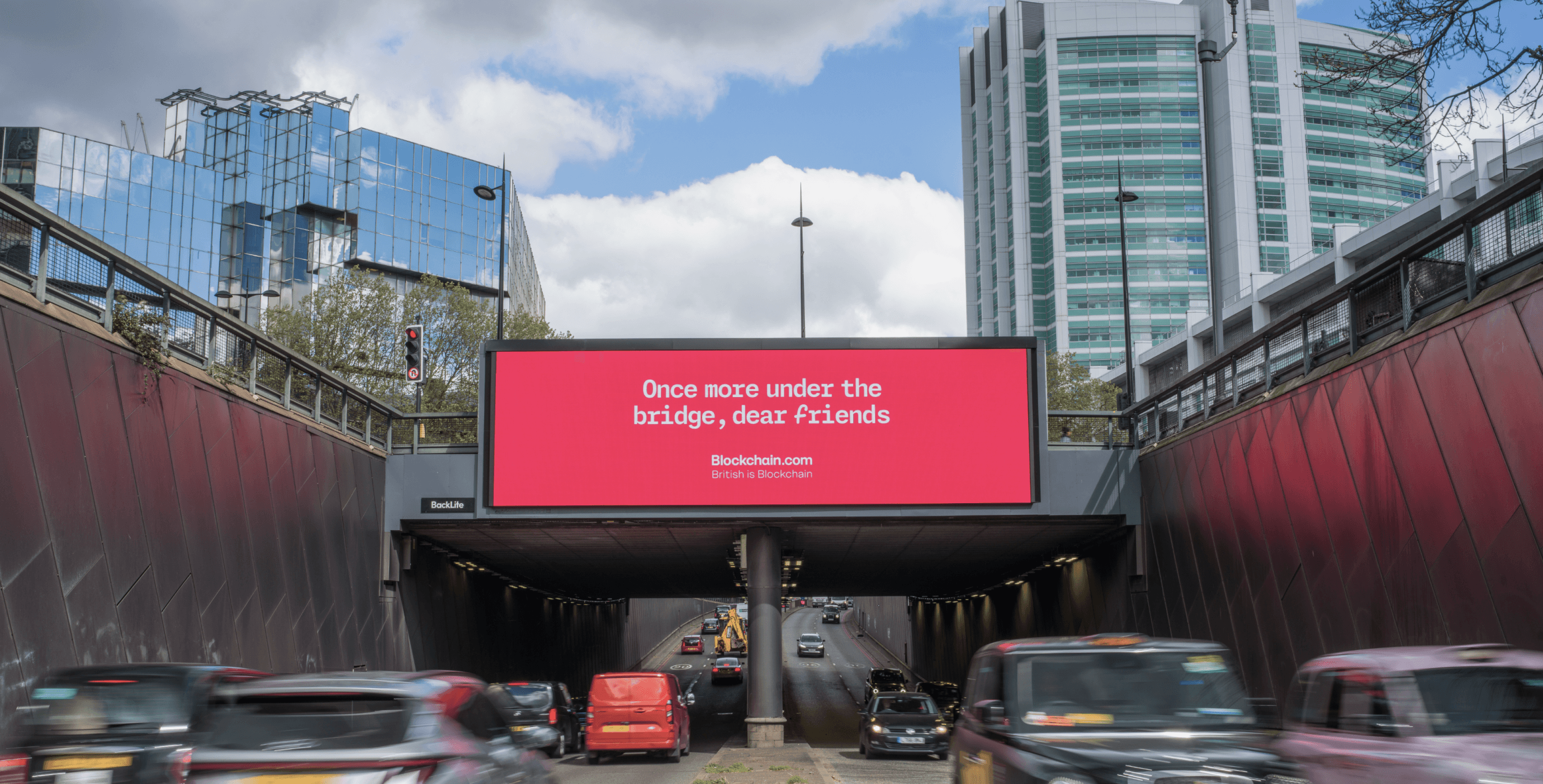 Blockchain.com ‘Once more under the bridge, dear friends’ billboard over a road