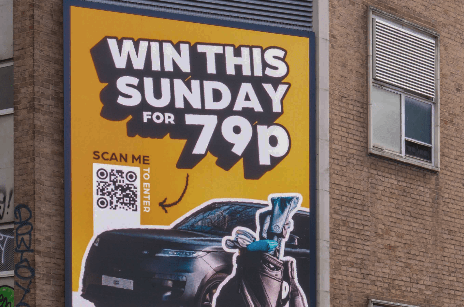 Caddy Comps billboard beside a passing London bus