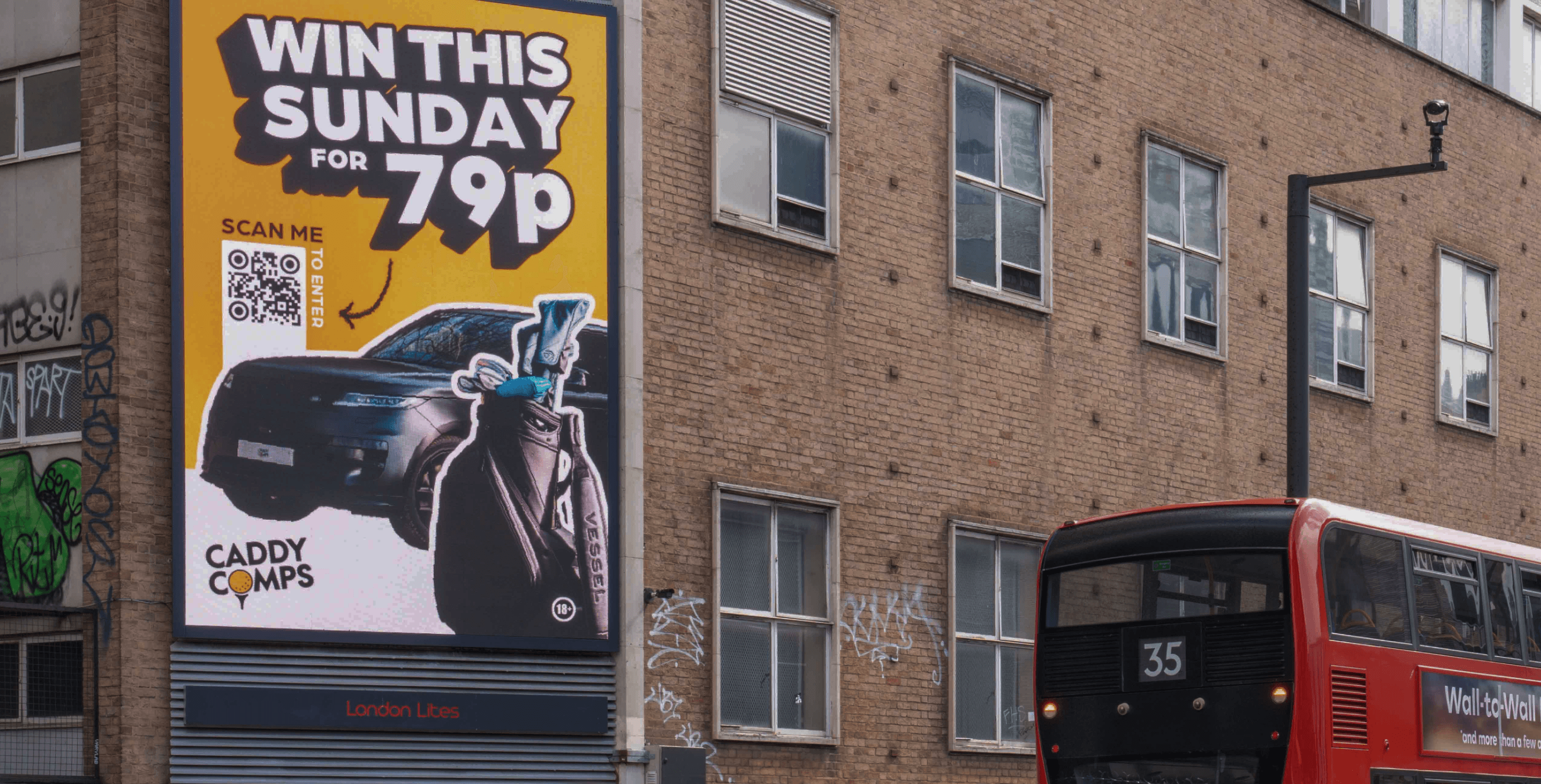 Caddy Comps ‘Win This Sunday for 79p’ billboard with a red bus passing