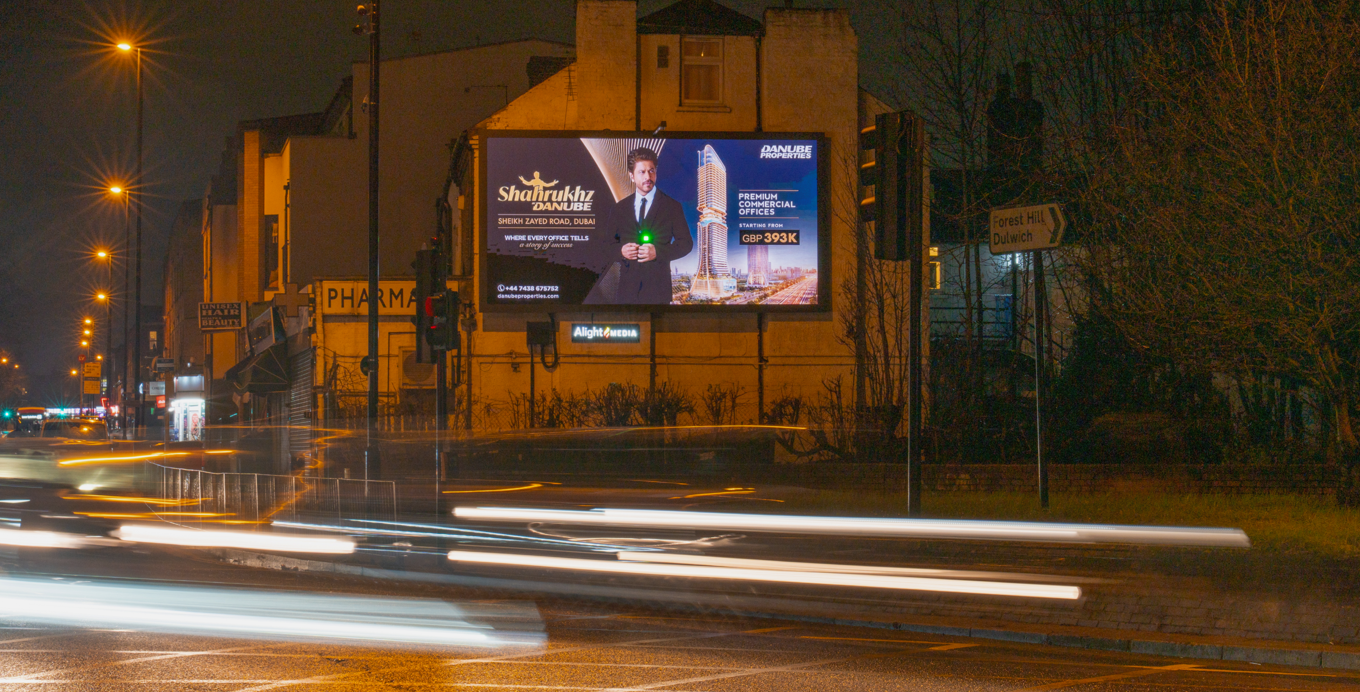 Danube Properties billboard beside a Forest Hill junction at night