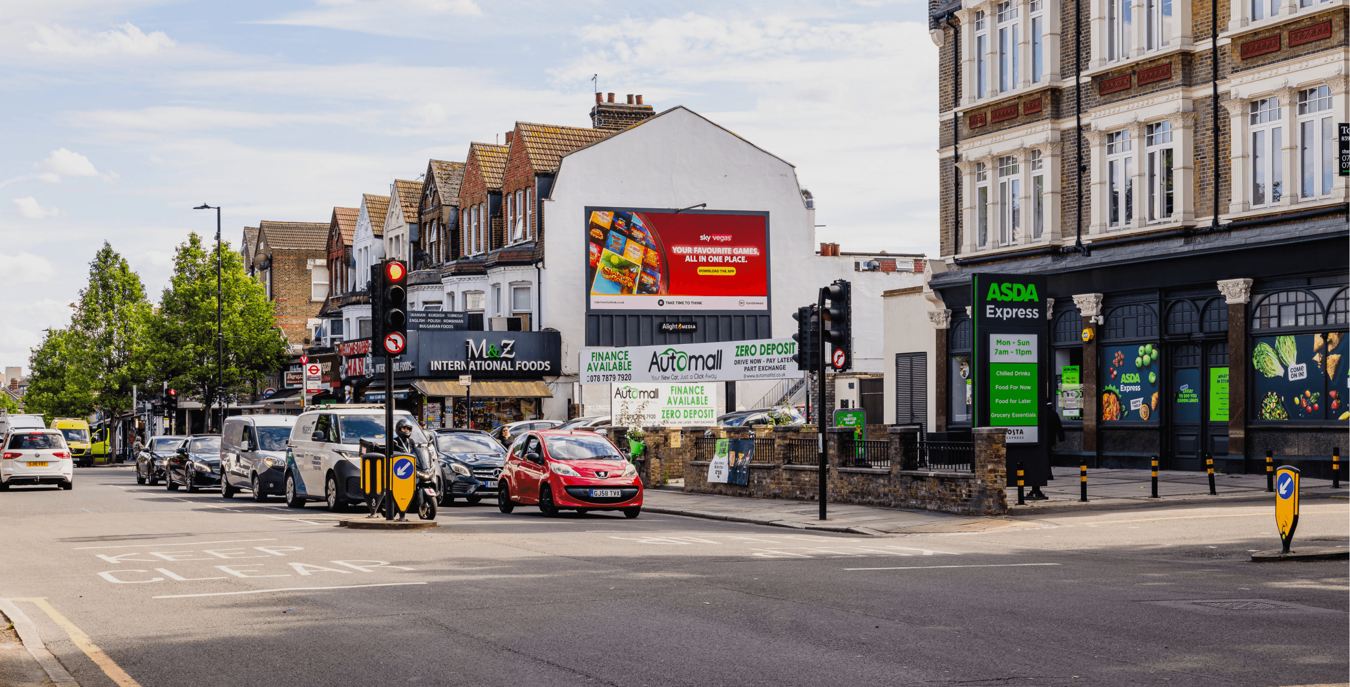 Sky Vegas ‘Your Favourite Games, All In One Place’ billboard above an ASDA Express