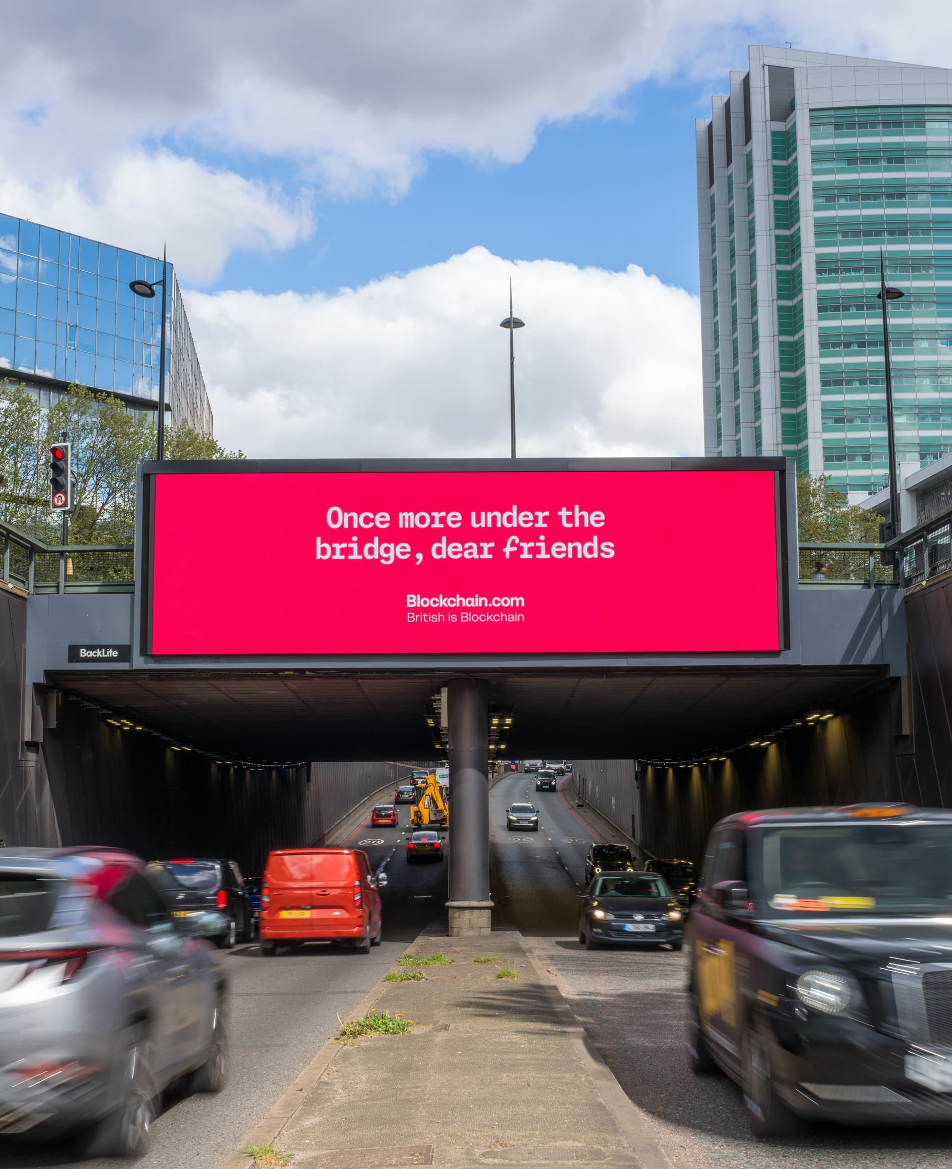 Blockchain.com digital billboard above a London underpass with traffic passing beneath