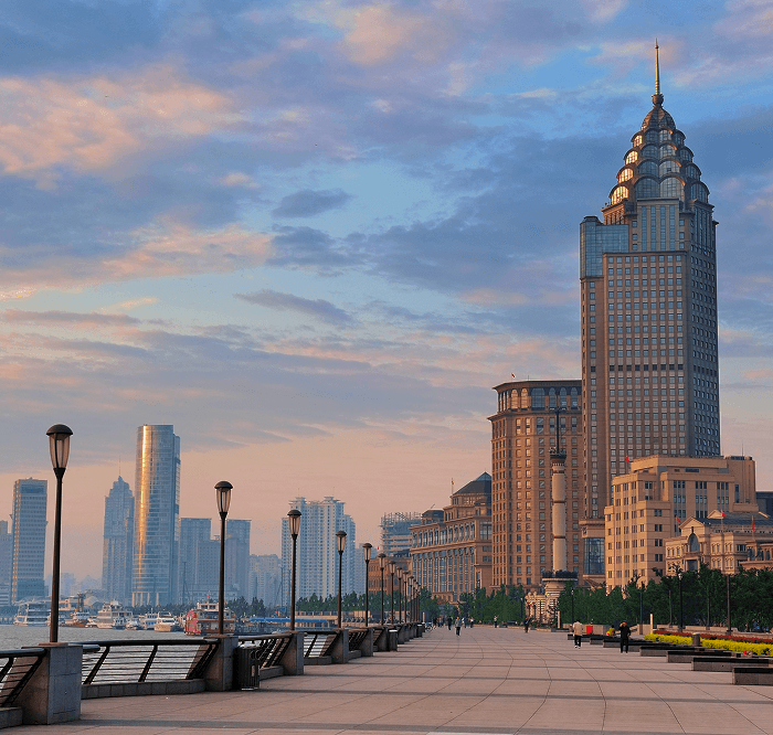 Harbour-front promenade lined with skyscrapers at sunrise